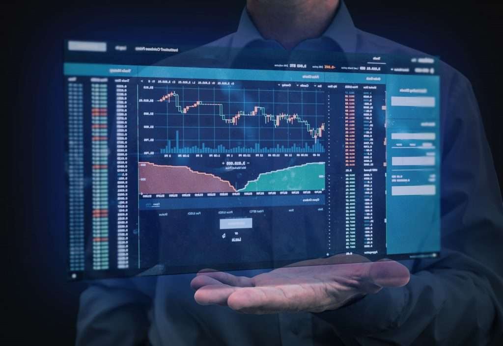 Man holding a screen that displays crypto diagram